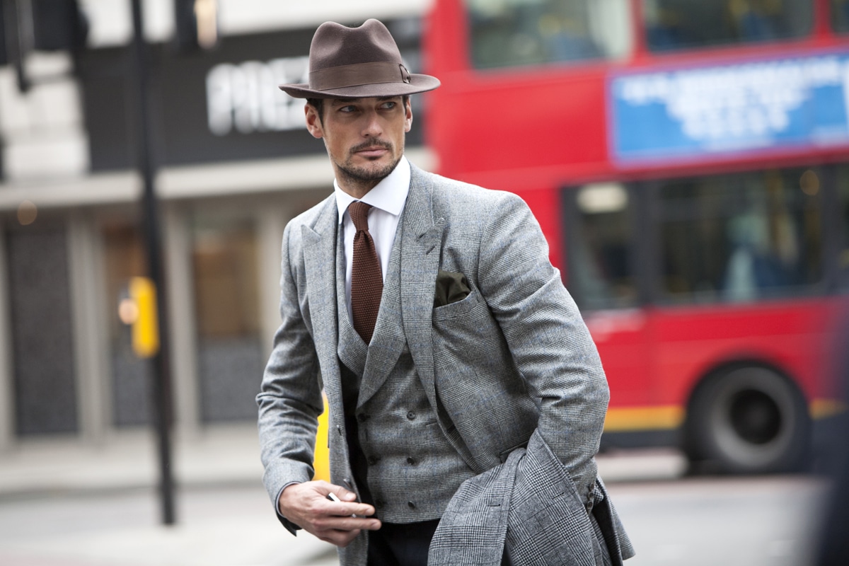 confident men wear suit with cap