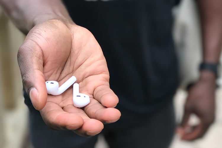 apple airpods wireless earbuds on the hand