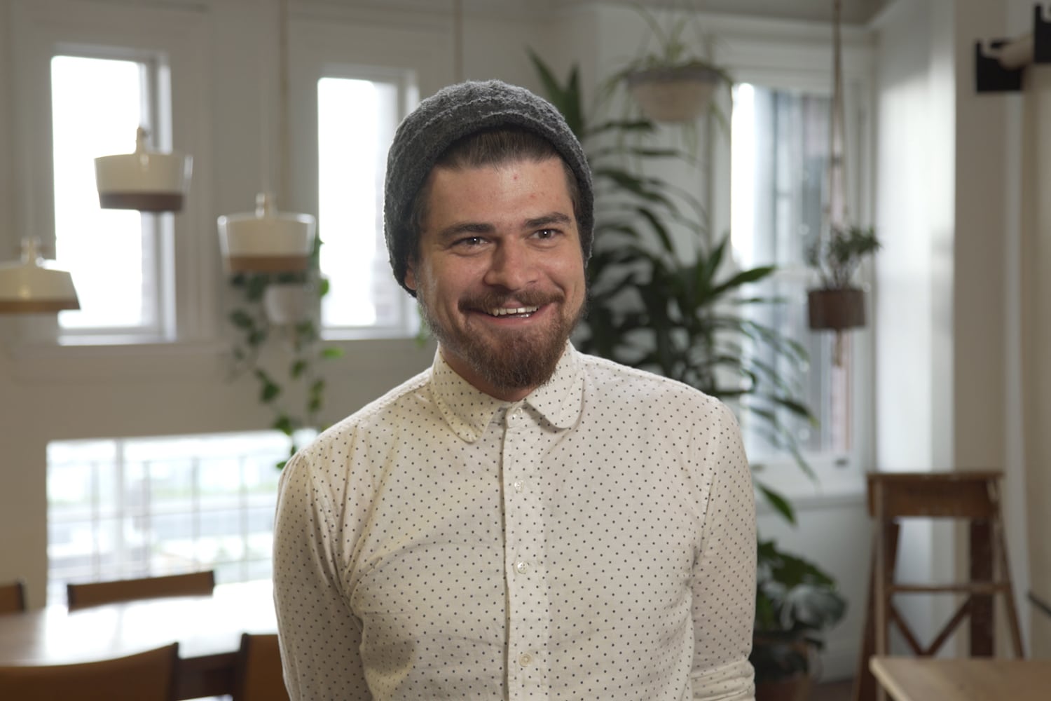 man wear polka dot shirt with smiling face