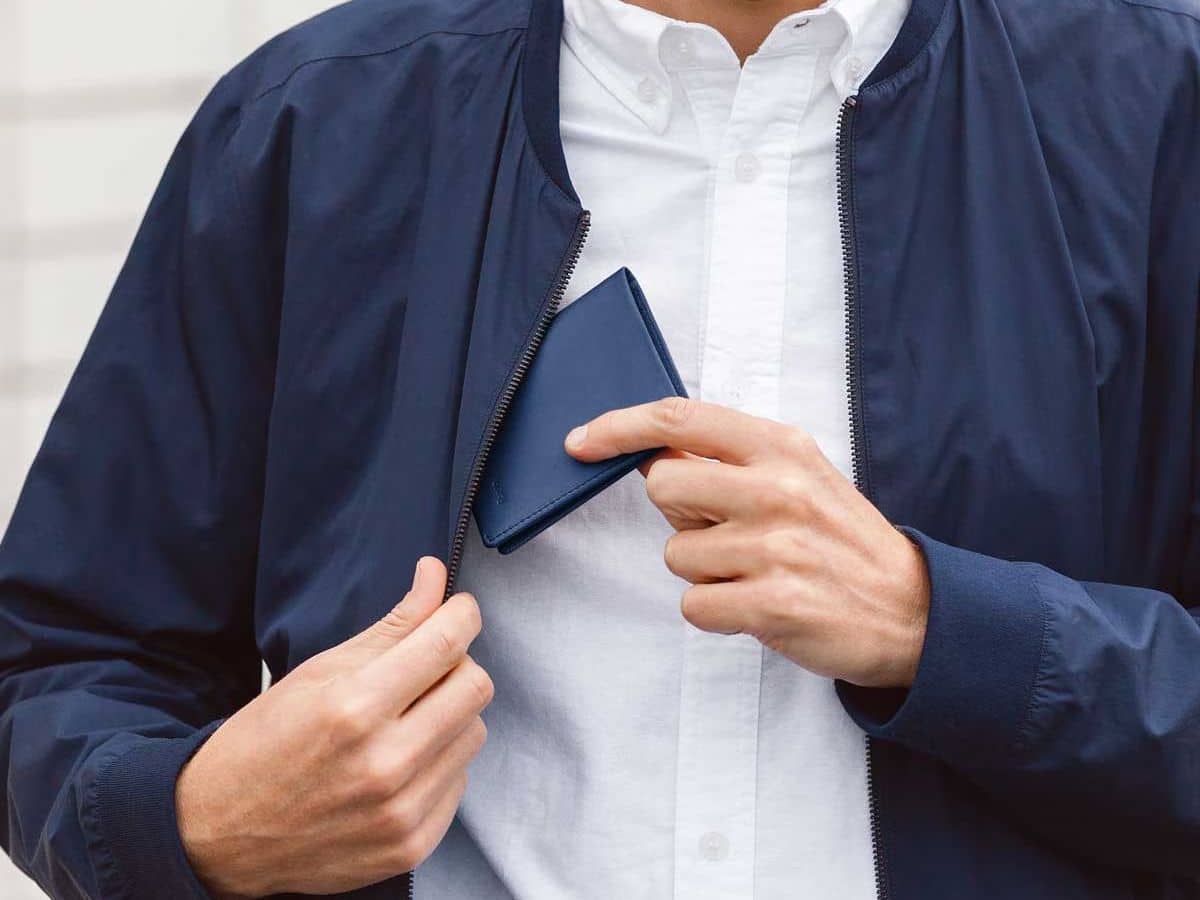 Man putting wallet in inside pocket