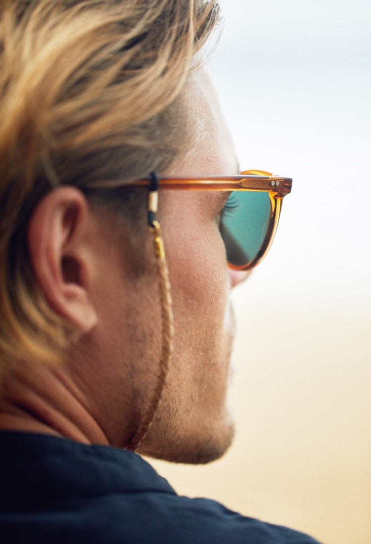 a man is looking through pacifico sunglass