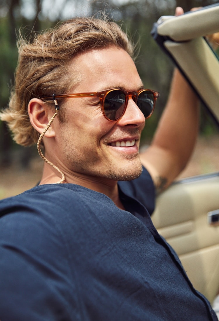 nice man inside a car with pacifico sunglass