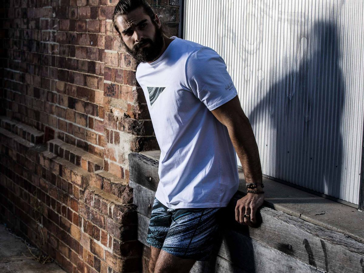A model in SQD Athletica Kinesis Collection brand tee and a running short