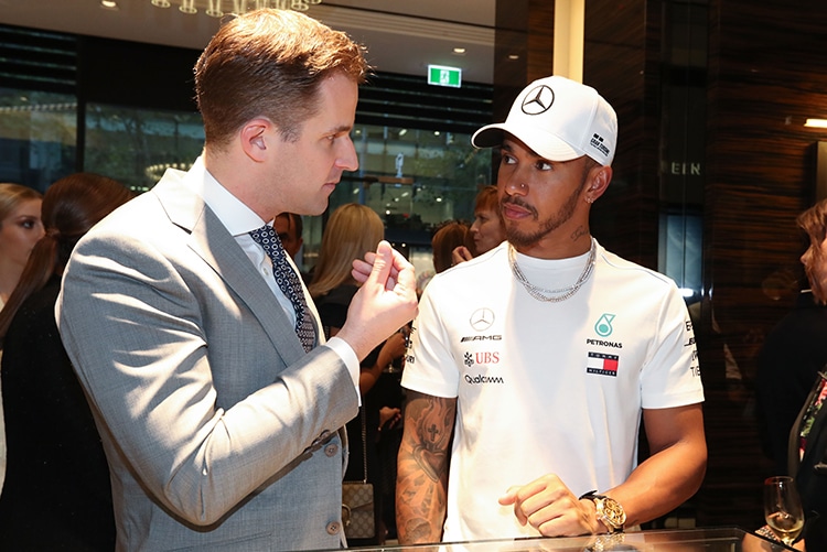 f1 racing player talking with men
