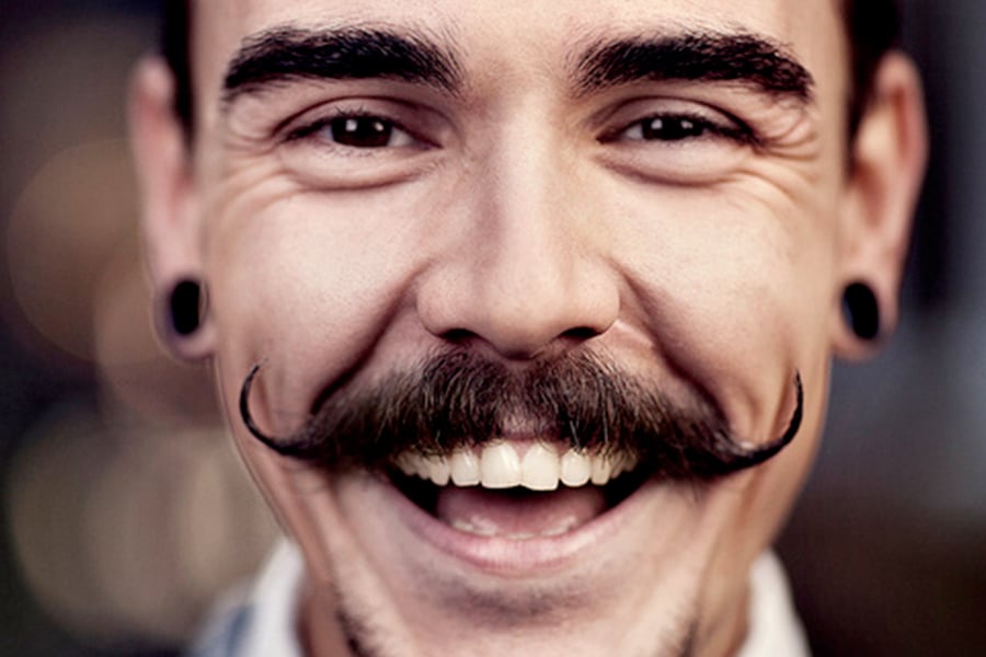 Handlebar mustache with stretched ear piercing