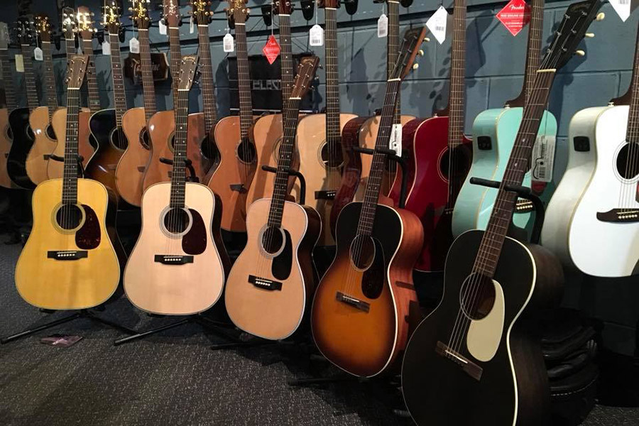 assorted acoustic guitars lined up