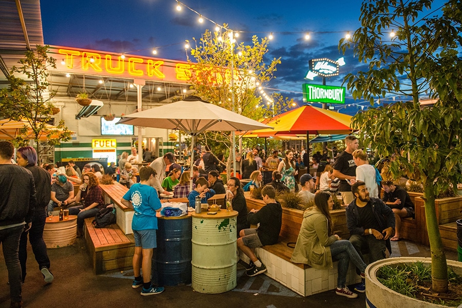 night time courtyard with benches and crowd