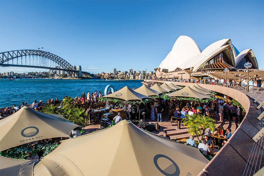 opera bar under umbrellas with opera house 