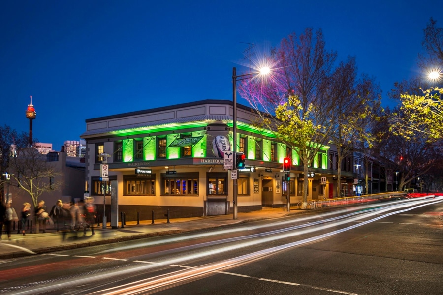 harlequin inn facade against cityscape night