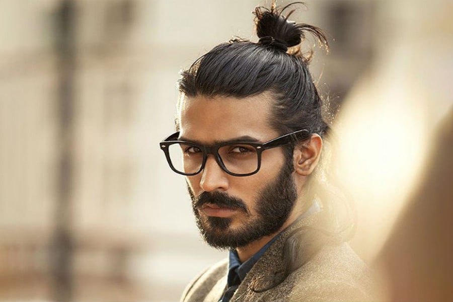 messy top bun with bushy medium beard