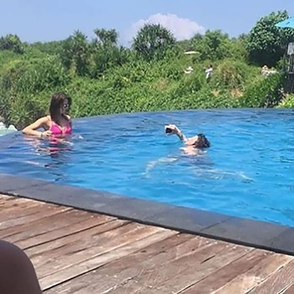 women capture her image standing in pool