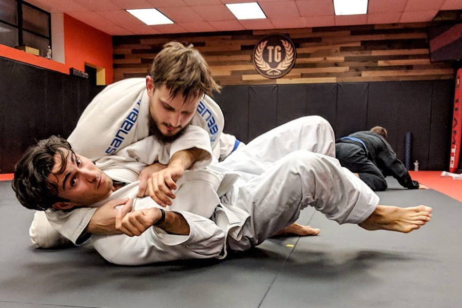 People practicing BJJ at Training Grounds gym