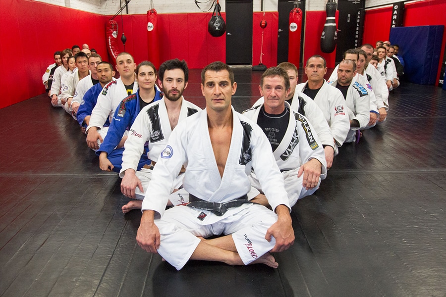 Carlson Gracie trainers in V formation on floor