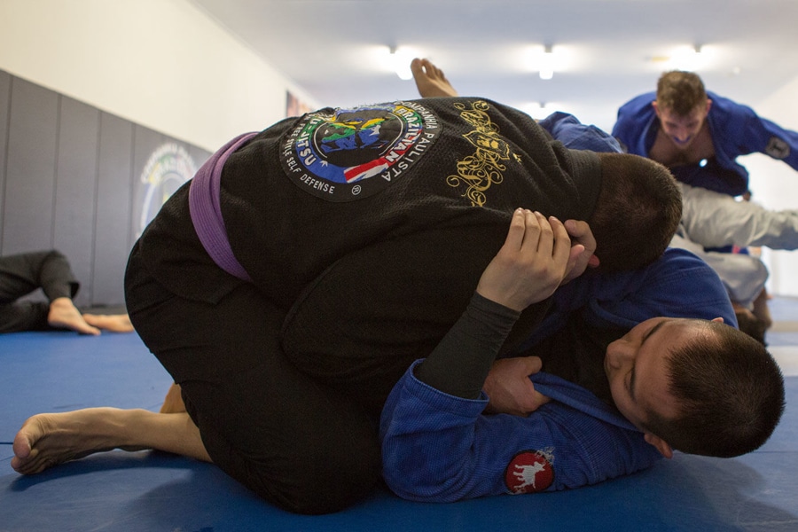 Two men fighting Jiu Jitsu