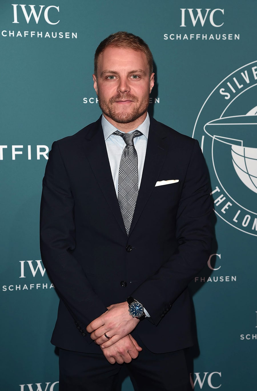 Valtteri Bottas infront of blue panel