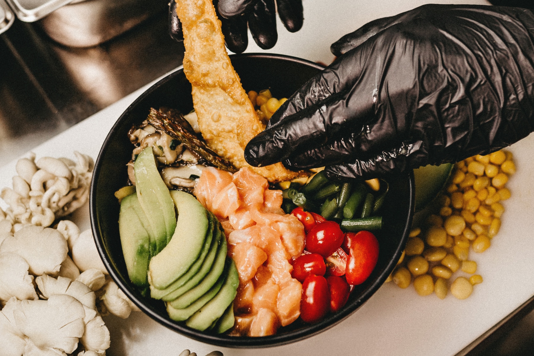 Hand preparing Poke Bowl