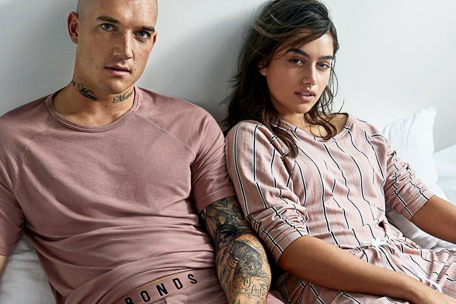 couple in bed wearing pink bonds clothing