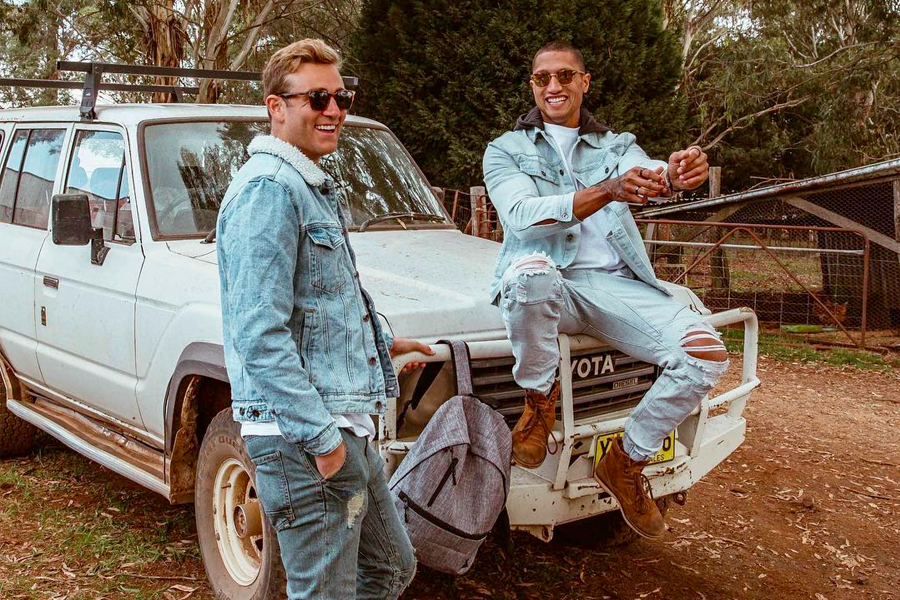 two men in cotton on denim outfit on car