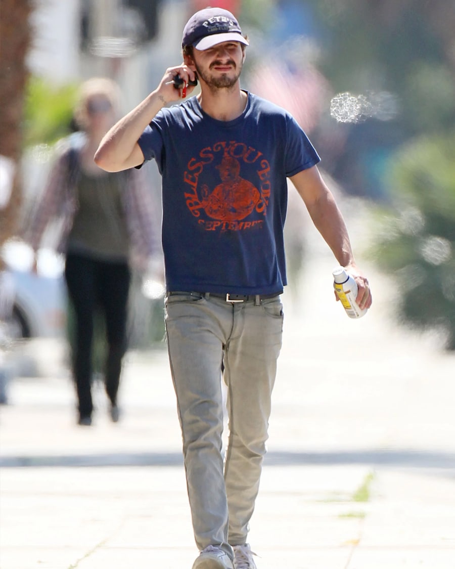 Shia Labeouf on phone on sidewalk