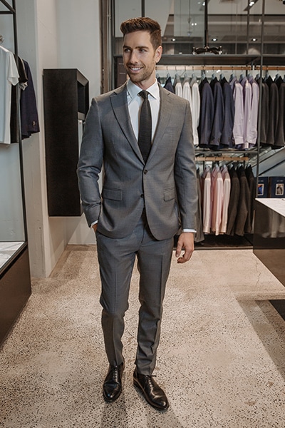 grey suit blue tie black shoes