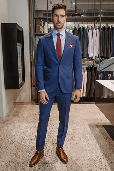 good looking guy in blue suit and red tie