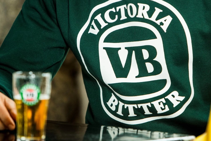 VB glass of beer in front of person wearing VB logo t-shirt