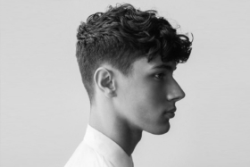 Side of man with curly haircut