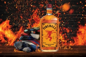 Bottle of Fireball with fire graphics in background