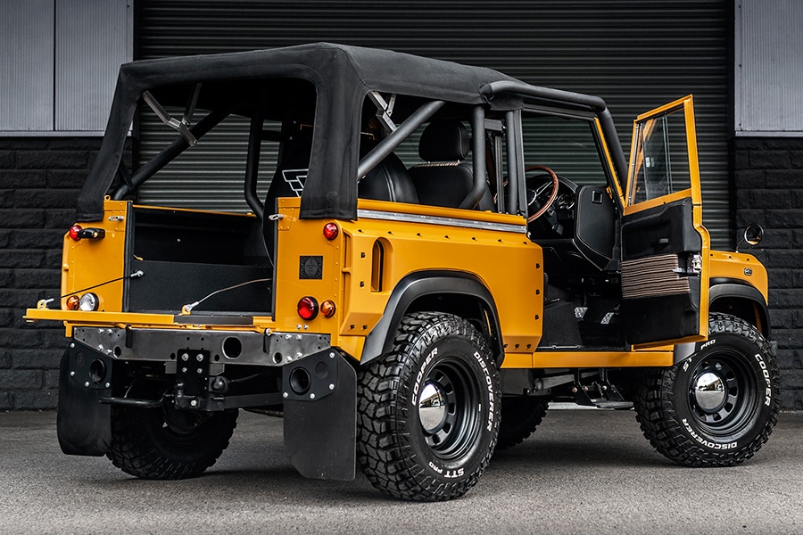 land rover defender back view with open door