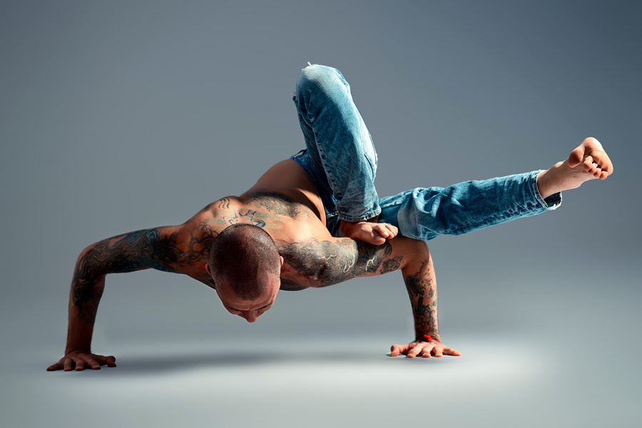 A man balancing his body on his hands in a Yoga position