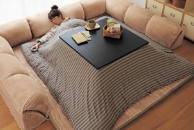 Woman sleeping under Kotatsu Japanese Heated Table