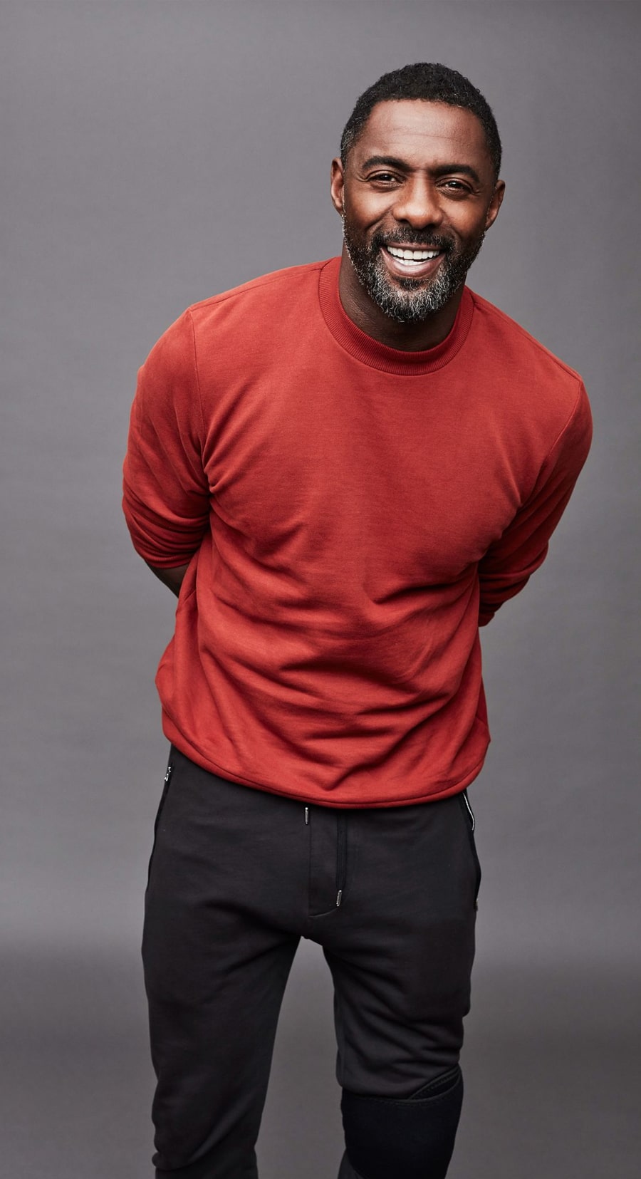 Idris Elba in red sweater