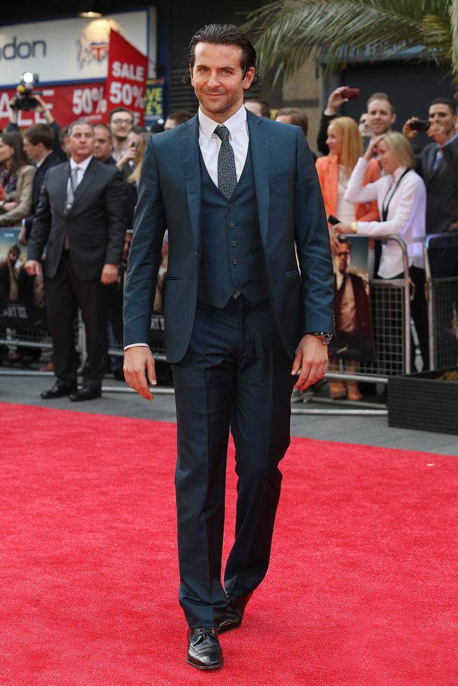 Bradley Cooper in a gray suit at a red carpet