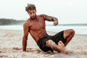 A man exercising on a beach