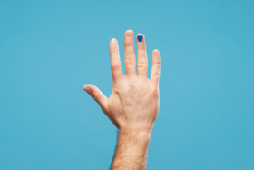 A man's hand with a polished nail