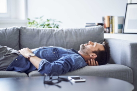A man sleeping on a sofa