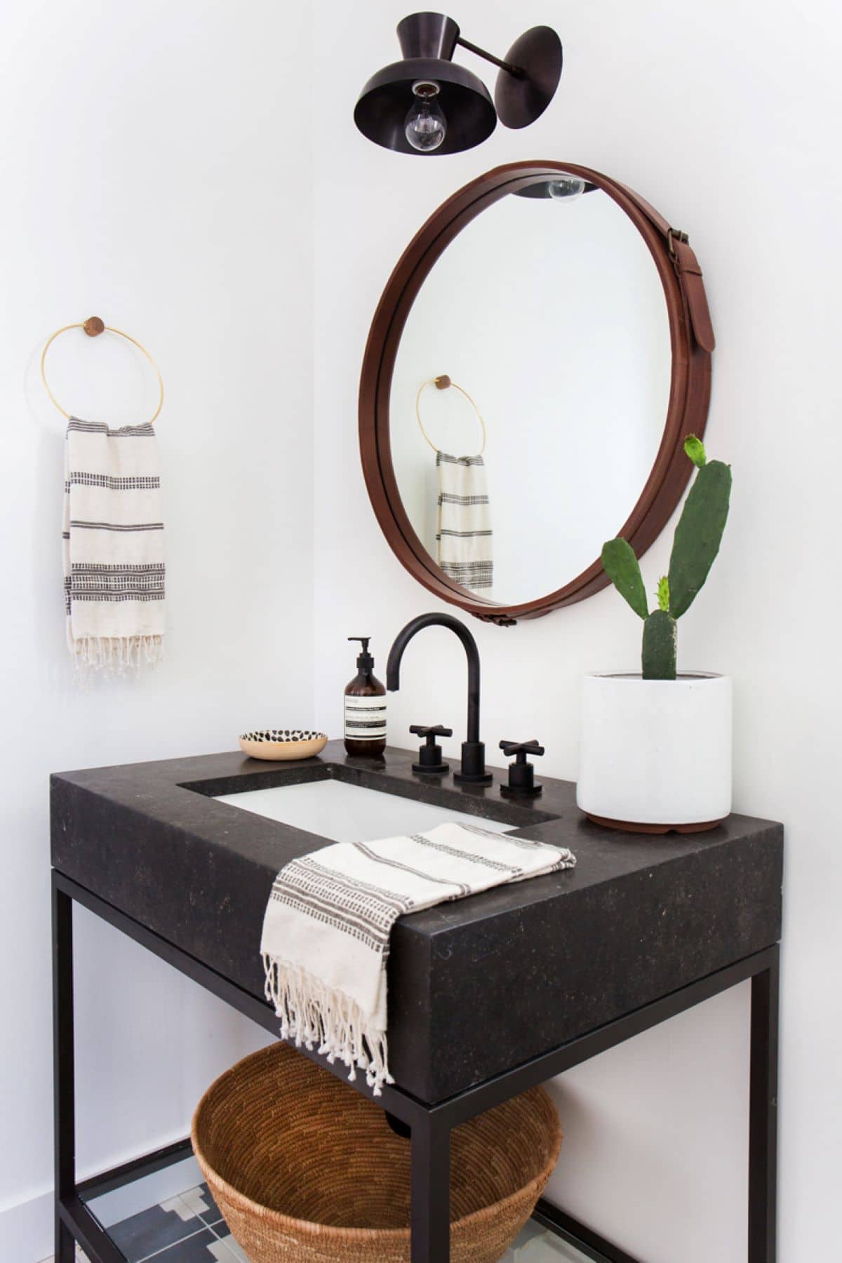 Black marble sink in a white wall bathroom