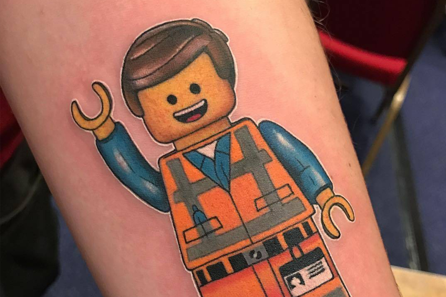 Coloured tattoo of a LEGO figure on a man's arm