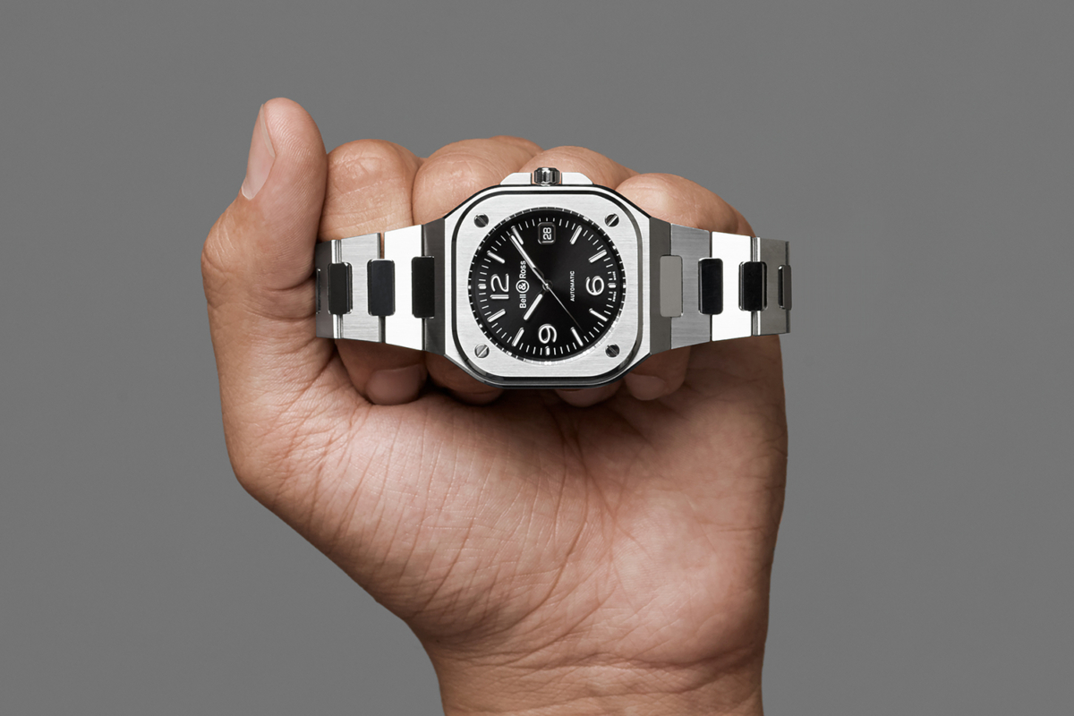 A fist with Bell & Ross BR05 watch on fingers
