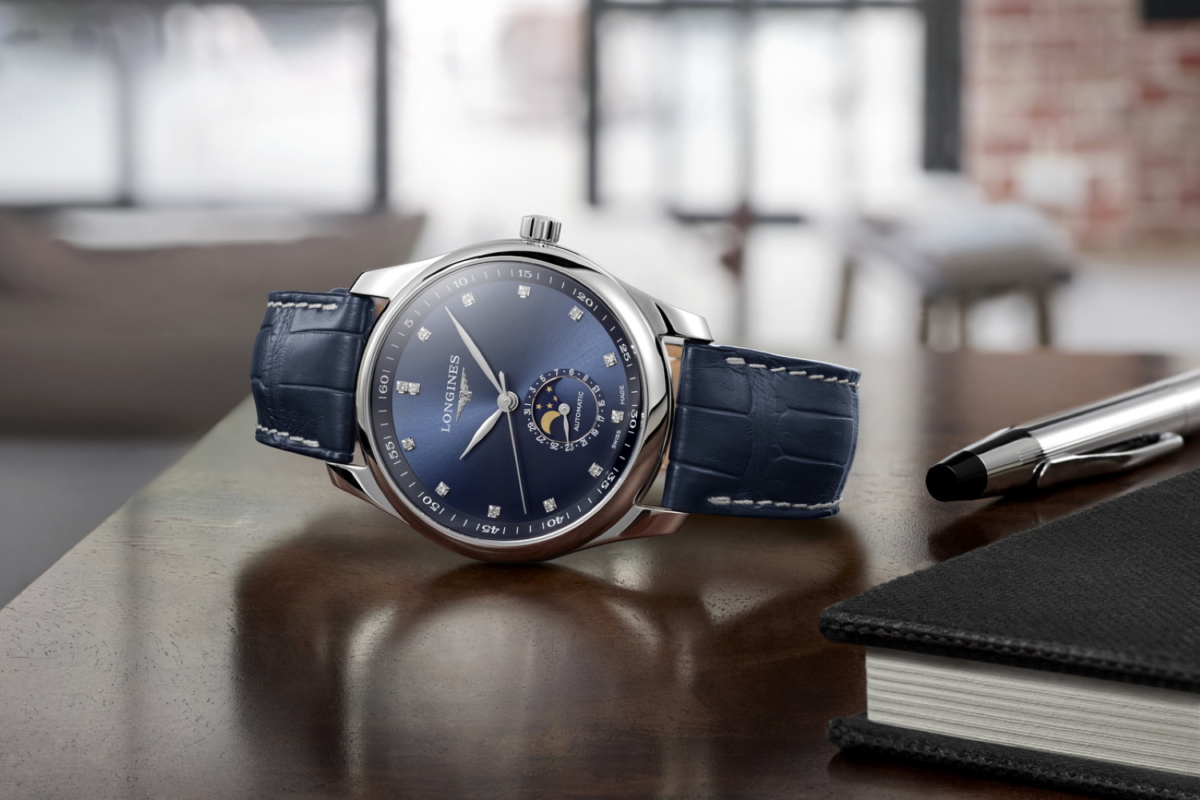 A blue dial Longines watch on its side
