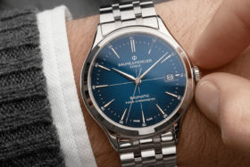 A Clifton Baumatic 10468 watch on a wrist being wound by a hand