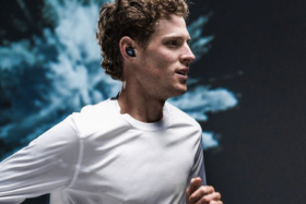 Man running wearing Jaybird Vista headphones