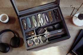 Drop Cache Display Valet filled with knives, sunglasses, watches, pens and wallet