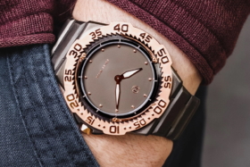 A copper bezel Nove Dive Watch on a wrist