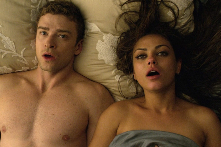 Justin Timberlake and Mila Kunis in bed with their mouths open in Friends with Benefits