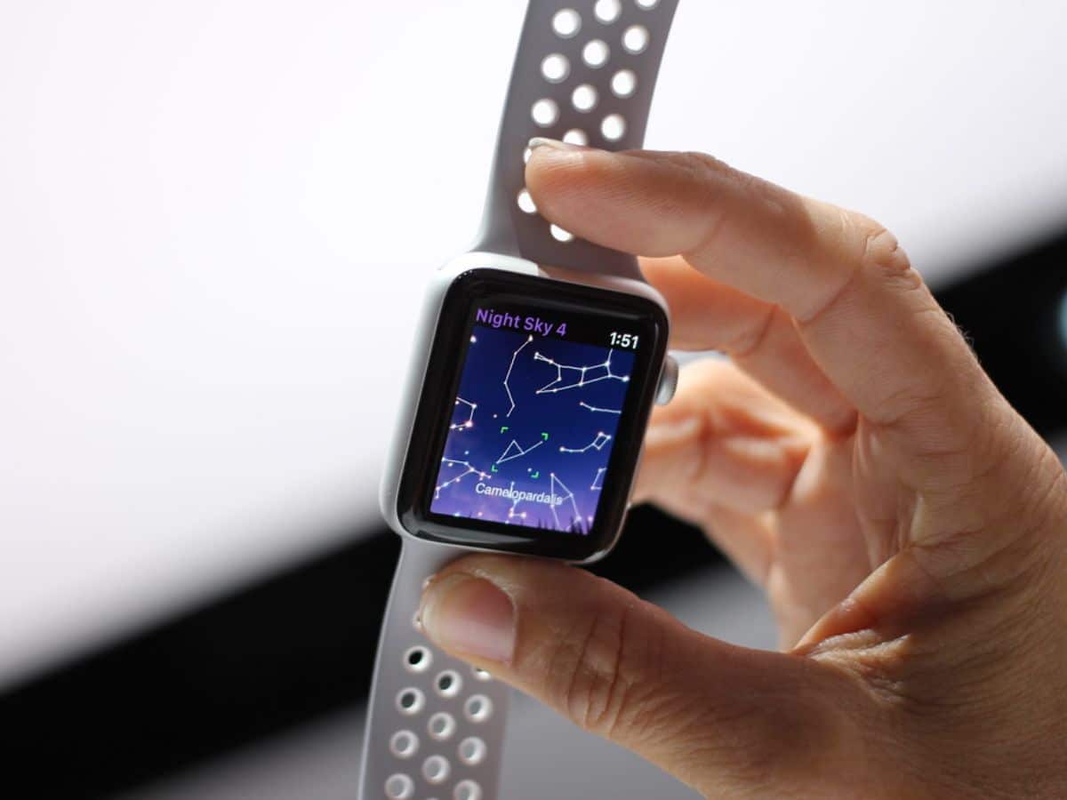 Apple watch in a hand with Night Sky app showing constellations