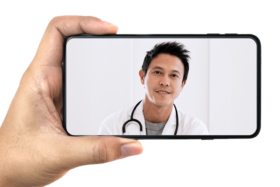 A hand holding a phone with a doctor on screen
