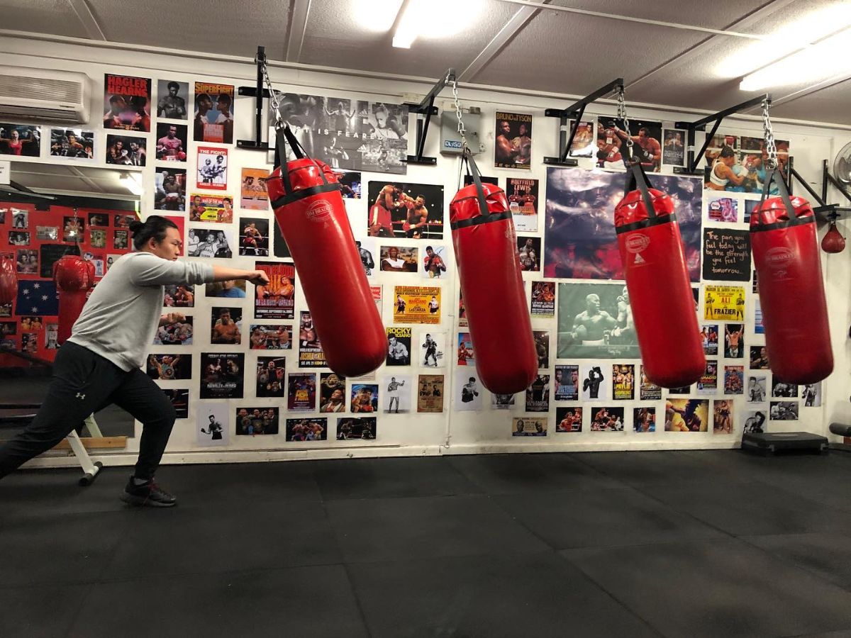 A man punching punching bags at Knockout Fitness and Boxing Forest Hill