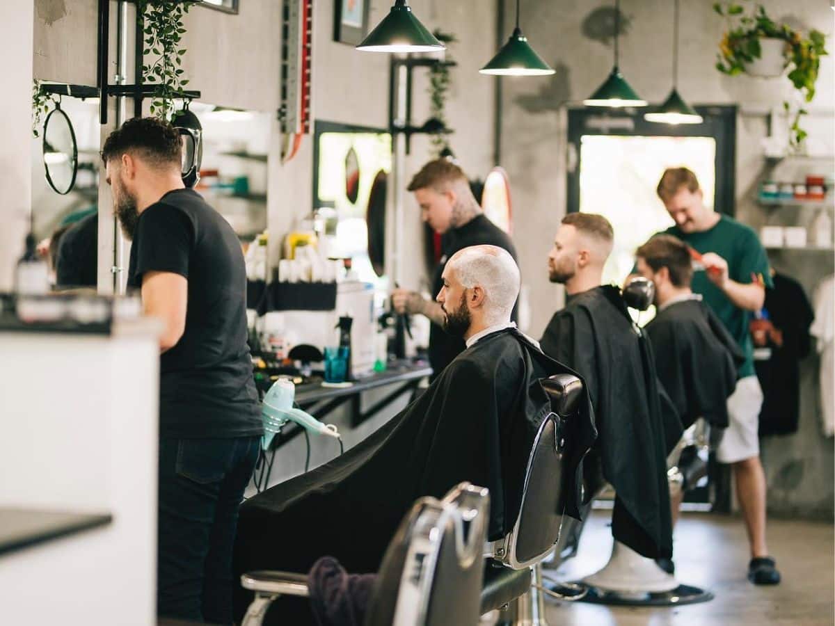 People getting a haircut at Stanford Barbers