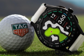 TAG Heuer Connected Golf Edition watch leaning on a golf ball on grass